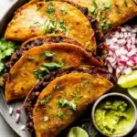 Crispy sheet pan black bean tacos served with toppings