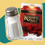 Coarse kosher salt crystals in a wooden bowl, perfect for seasoning dishes.