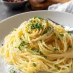 Delicious Garlic Butter Pasta garnished with fresh parsley and cheese