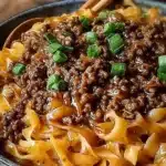 Delicious Mongolian ground beef noodles served in a bowl with vegetables.