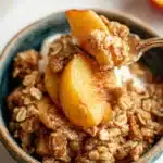 Delicious homemade Peach Crisp topped with crunchy oat and brown sugar crumble.