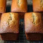 Slice of Cinnamon Applesauce Quick Bread on a wooden table