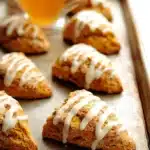 Cozy pumpkin scones topped with spices and drizzled with glaze