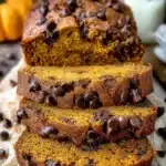 Delicious slice of pumpkin chocolate chip bread on a wooden table