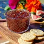 Homemade simple fig jam in a jar with fresh figs and a slice of bread