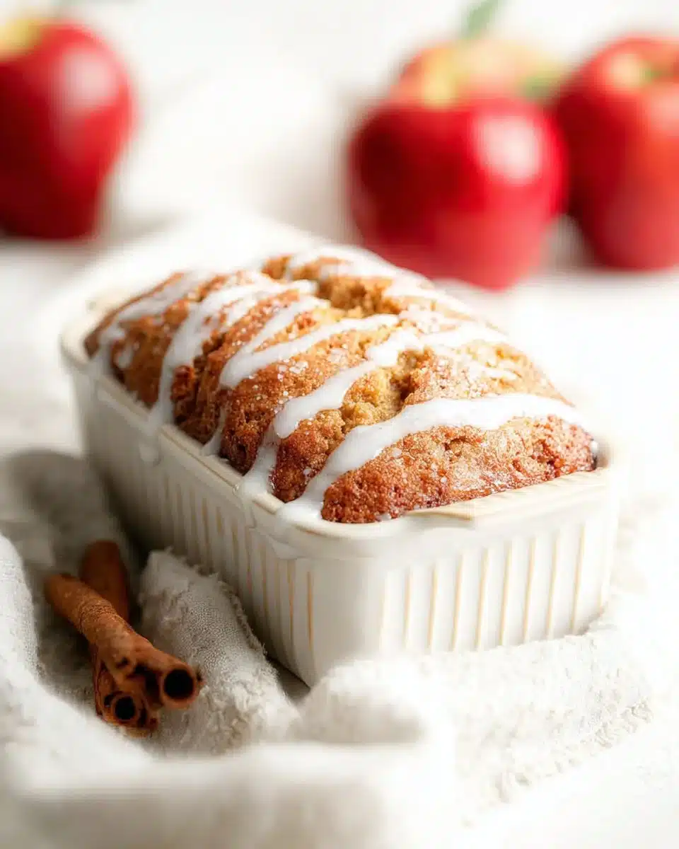 Freshly baked apple bread with slices on a wooden cutting board