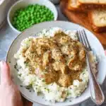 Chicken and gravy served over mashed potatoes in a delicious, comforting meal.