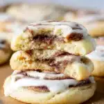 Freshly baked cinnamon roll cookies with frosting on a plate