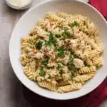 Crockpot Garlic Parmesan Chicken Pasta topped with parsley in a bowl