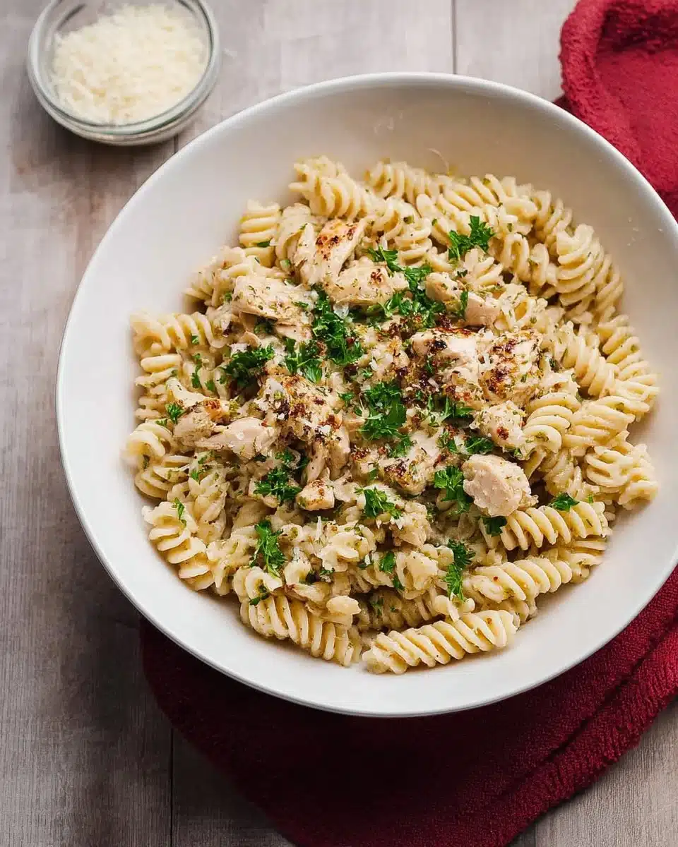 Crockpot Garlic Parmesan Chicken Pasta topped with parsley in a bowl