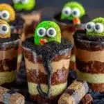 Delicious Dirt Pudding Cups served in clear cups with gummy worms and crushed cookies
