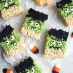Frankenstein Halloween Rice Krispie treats decorated with green icing and candy eyes