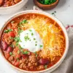 Bowl of hearty ground turkey chili topped with fresh cilantro and cheese