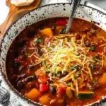 Bowl of healthy pumpkin chili topped with herbs and spices