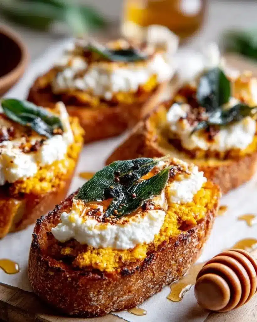 Pumpkin Crostini with ricotta cheese and crispy sage garnished on a platter