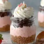 Delicious quick Neapolitan Cake in a Jar with layers of chocolate, vanilla, and strawberry.