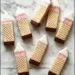 Delicious wafer pencil cookies arranged on a plate