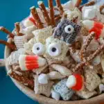 Delicious White Chocolate Halloween Chex Mix with festive treats and colorful candy.