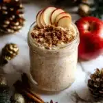 Bowl of apple pie overnight oats topped with apple slices and cinnamon
