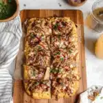 Delicious BBQ chicken flatbread pizza topped with cheese and cilantro