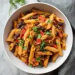 Plate of Black Bean Fajita Pasta with colorful vegetables and spices