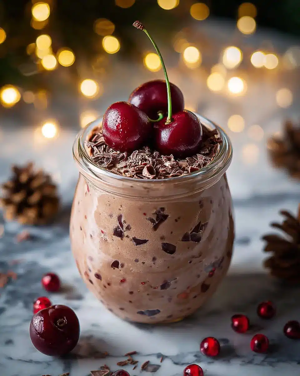 Bowl of chocolate cherry overnight oats topped with cherries and chocolate chips