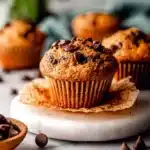 Delicious homemade chocolate chip protein muffins on a wooden table.