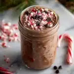 Chocolate peppermint overnight oats topped with whipped cream and peppermint sprinkles