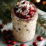 Delicious Coconut Cranberry Overnight Oats in a bowl, topped with coconut flakes and cranberries.