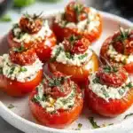 Cottage cheese and sun-dried tomato stuffed cherry tomatoes on a plate