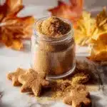 A jar of homemade gingerbread spice blend for festive baking.