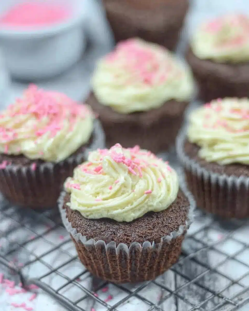 Gluten-free dairy-free chocolate protein cupcakes topped with chocolate frosting