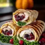 Harvest Turkey and Cranberry Wraps with fresh ingredients on a wooden board