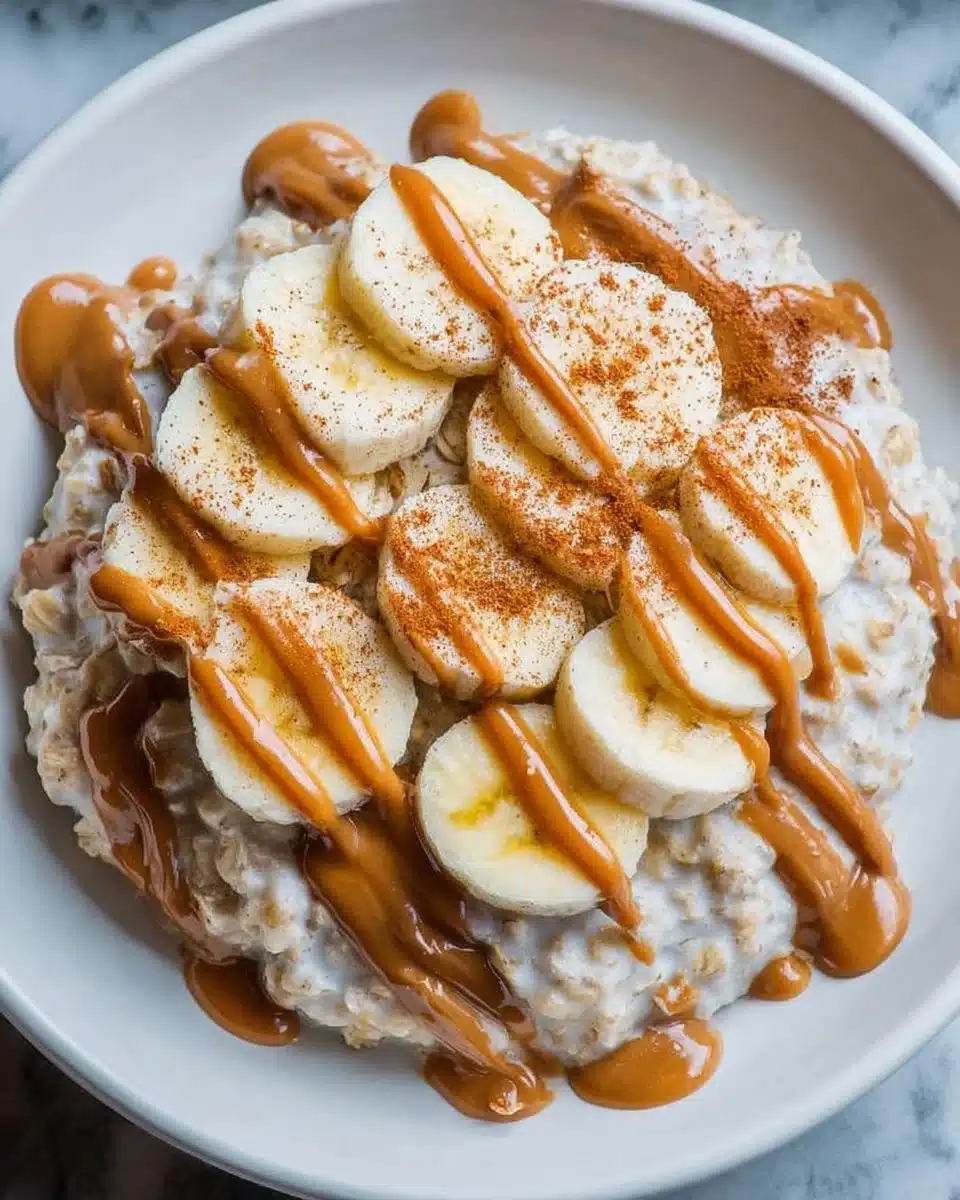 Bowl of oatmeal topped with banana slices and a dollop of peanut butter