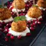 Golden brown Parmesan rice balls served on a platter.
