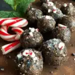 Peppermint mocha energy bites on a wooden table with festive decorations