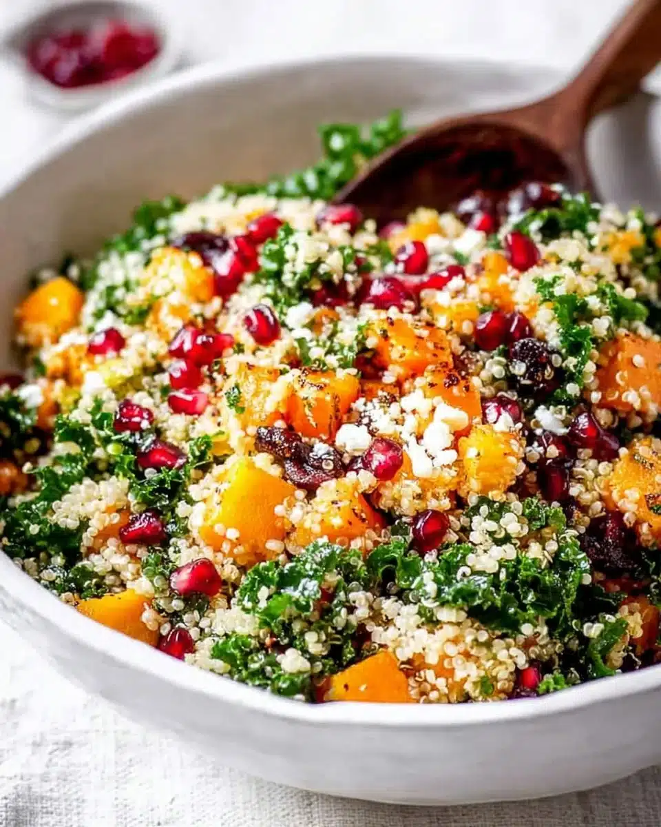 Quinoa salad with pomegranate, kale, and butternut squash served in a bowl
