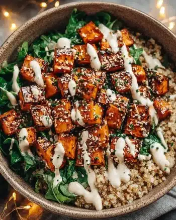 Sweet Potato Tahini Bowl topped with fresh vegetables.
