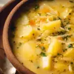 Creamy Instant Pot potato soup in a bowl garnished with herbs