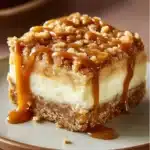 Caramel Apple Cheesecake Bars topped with crispy streusel