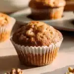 Freshly baked apple walnut muffins with chunks of apple and walnuts