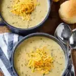 Bowl of creamy zucchini soup garnished with fresh herbs and drizzled with olive oil