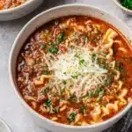 Bowl of Easy Beef Lasagna Soup garnished with herbs and cheese
