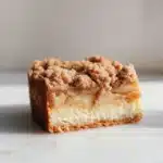 Gluten-free apple cheesecake bars with a creamy filling and apple topping