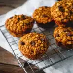 Homemade pumpkin chocolate chip oatmeal muffins on a wooden table