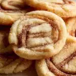 Delicious soft and chewy cinnamon roll sugar cookies on a plate