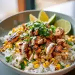 Street Corn Chicken Rice Bowl topped with fresh corn and spices.