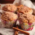 Delicious sugar-free apple cinnamon muffins on a wooden table.