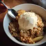Sugar Free Apple Crisp dessert in a baking dish with apples and oat topping