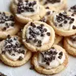A plate of freshly baked Cannoli Cookies with creamy filling and crispy edges.